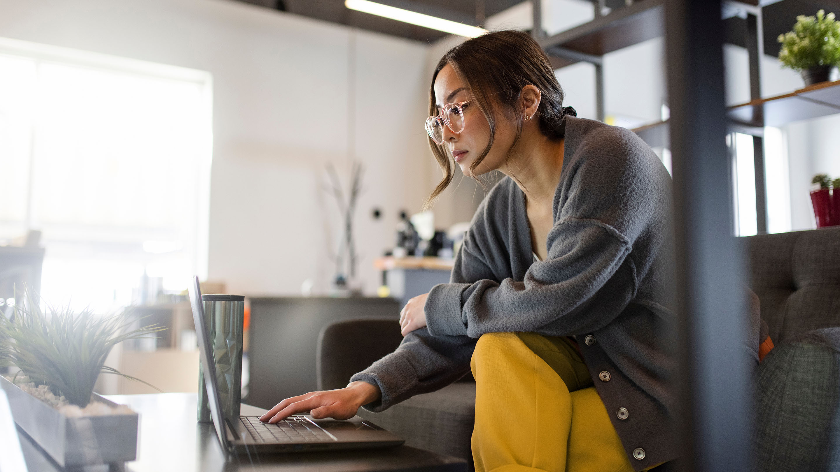 Person sat in a living room using a laptop
